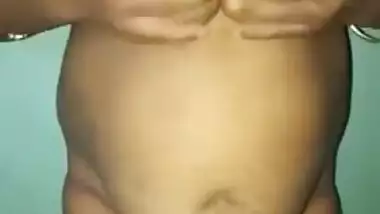 Desi woman with sexy fat tummy and big tits spreads pussy in XXX video