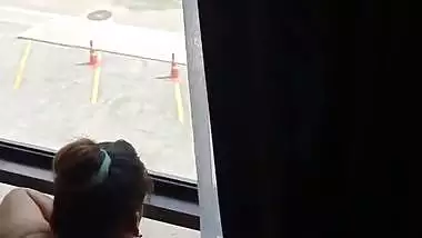 Lady fucks in front of a transparent glass in Indian porn