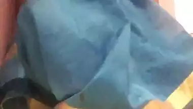 Amateur porn video where Desi MILF lifts blue dress to play with pussy